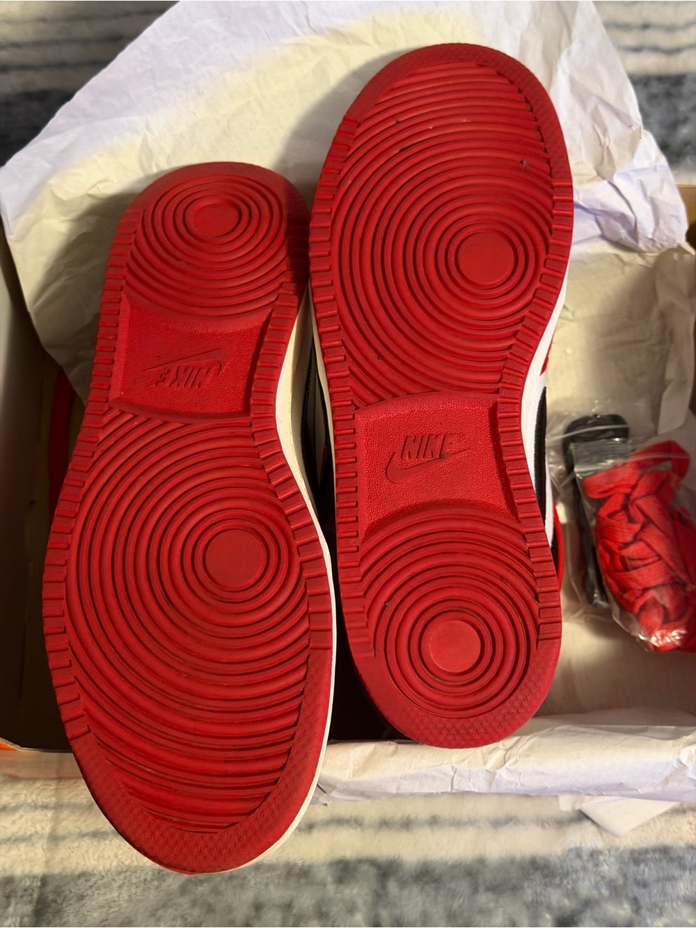 Nike Sneakers with Red Outsoles and Black Accents